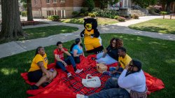 Deacon and students having a picnic together outside.