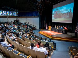 Bloomfield College staff and faculty on stage in front of parents in Westminster Theater