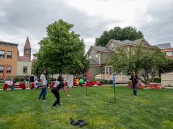 Three students playing volleyball on the Bloomfield campus green