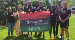 President Evans and students at NAACP Juneteenth Flag Raising on campus.