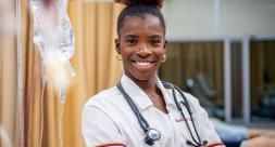 nursing student poses with stethoscope around neck