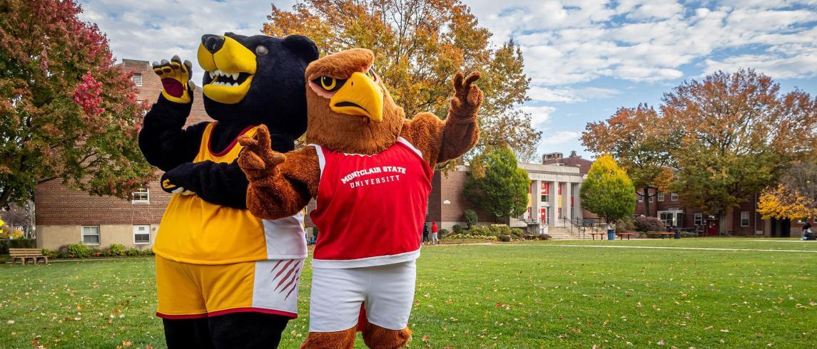 Bloomfield Bear Mascot and Rocky the Red Hawk pose back to back on Bloomfield campus