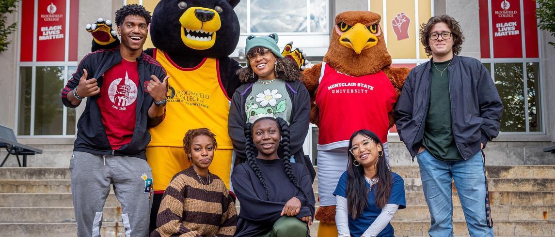 Bloomfield Bear Mascot, Rocky the Red Hawk, and students pose at Bloomfield campus